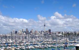 Neuseeland | Nordinsel, Skyline von Auckland, the "City of Sails". Boote im Hafen vor dem Panorama auf die Stadt Auckland. Die Stadt hat viele Sehenswürdigkeiten, viele Tipps zu den kostenlosen Highlights und zum Camping findest Du in unserem Reisebericht