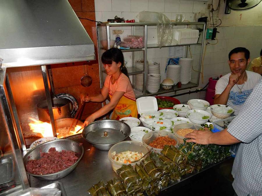 Vietnam | Norden, Bun Bo Nam Bo Restaurant in Hanoi. EIne Vietnamesin vor ihrem Wok kochend, Reisnudeln, Rindfleisch und Gewürze im Vordergrund